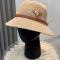 Prada Triangle Logo Knitted Bucket Hat in Cotton with Buckle Strap Beige